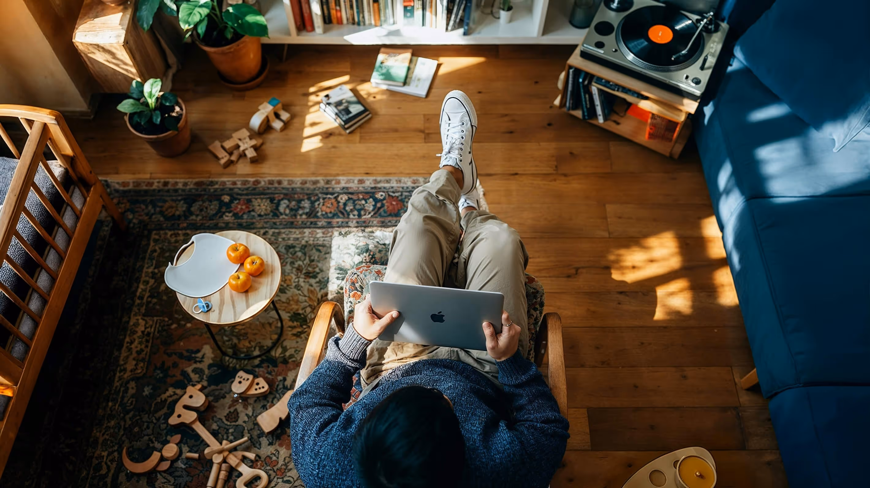 A man sitting on a couch using a laptop.
