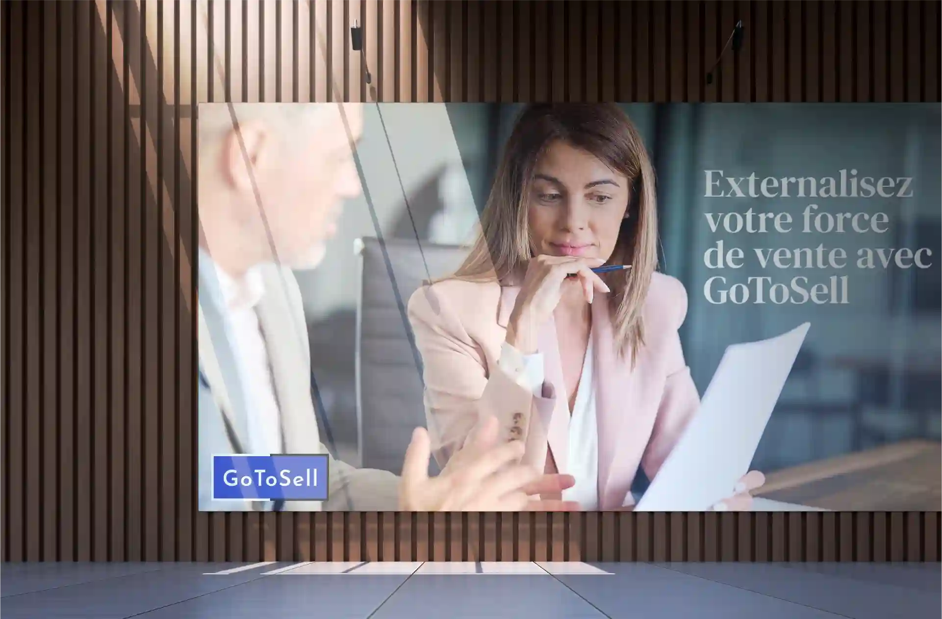 GotoSell billboard with a man and woman sitting at a table 