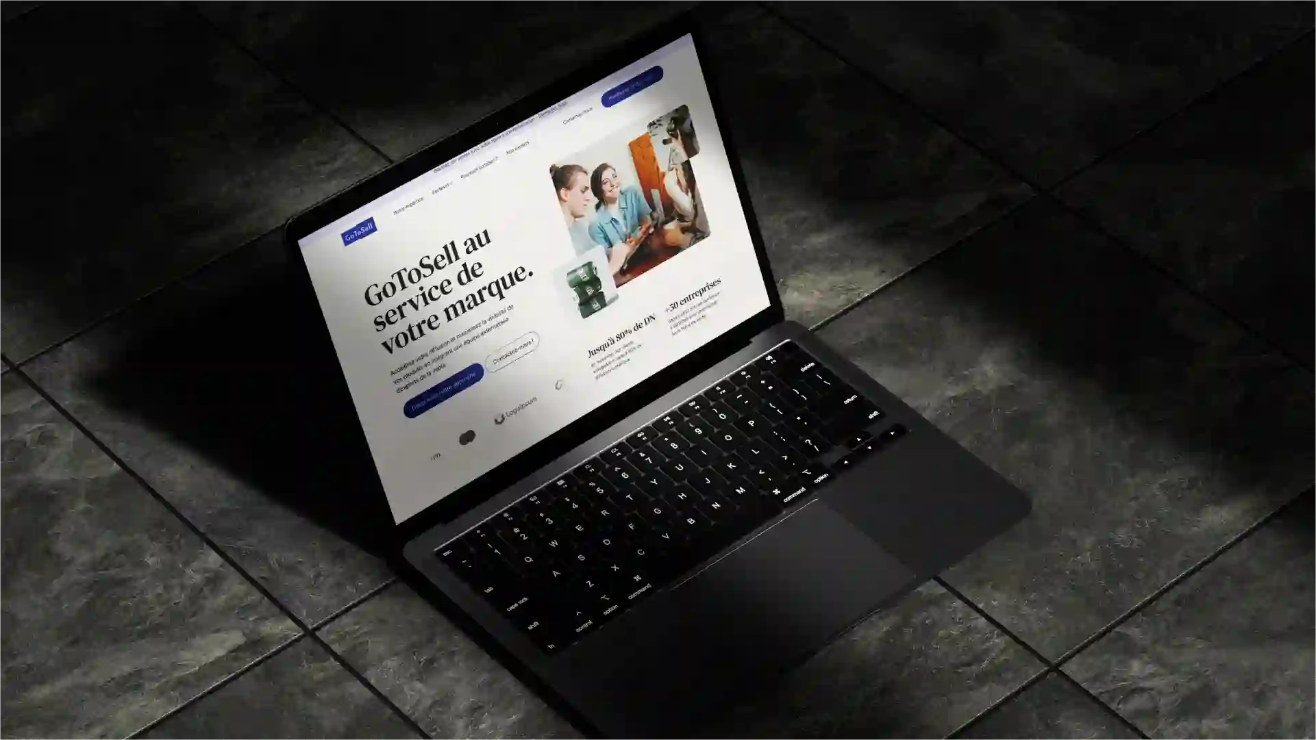A laptop computer sitting on the ground